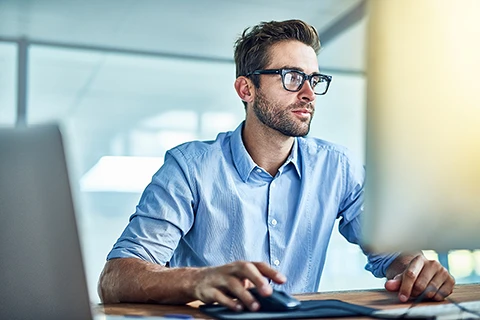 customer-experience-expert-odessa Man on a computer using Odessa's asset finance software to improve his customers' experience.